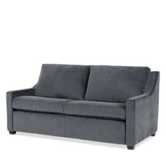 a gray couch sitting on top of a white floor