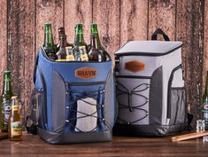 two cooler bags with beer bottles in front of them on a wooden table next to an ice chest