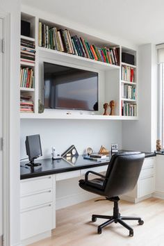 a home office with bookshelves, desk and chair in front of the tv