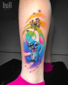 a woman's leg with a colorful tattoo on it