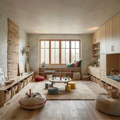 a living room filled with lots of furniture and wooden flooring next to a window