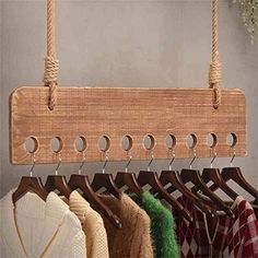 a wooden coat rack holding umbrellas and scarves