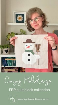 a woman holding up a piece of paper with a snowman on it and the words cozy holidays ppp quilt block collection