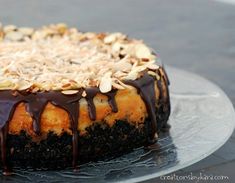 a cake covered in chocolate and nuts on a plate