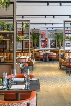 an empty restaurant with tables and orange chairs