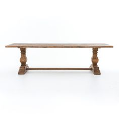 a wooden table sitting on top of a white floor