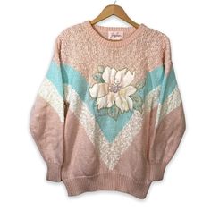 "Amazing vintage 80's sweater by Jaclyn Smith! This sweater features a pink, blue, and white design - embellished with a large flower in the center and beaded pearl-like beads. Super unique & cute! Size: Small Material: 86% Acrylic, 14% Nylon Approx. Measurements:  Length - 26.5\" Chest - 21\" In nice, vintage condition. Please see photos." Vintage Long Sleeve Sweater With Floral Print, Pink Knit Sweater With Floral Print, Vintage Embroidered Knit Sweater, Embroidered Vintage Knit Sweater, Vintage Pink Spring Sweater, Vintage Pink Sweater For Spring, Spring Vintage Pink Sweater, Pink Vintage Spring Sweater, Vintage Pink Knit Tops