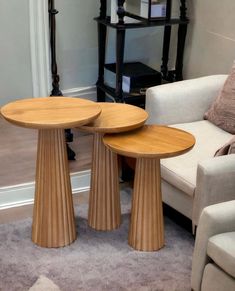 two wooden tables sitting on top of a carpeted floor