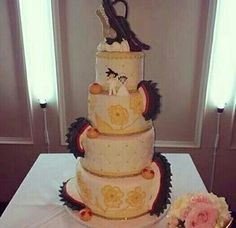 a three tiered wedding cake with high heels on top and flowers in the middle