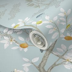 a wallpaper with a tree and birds on it in pastel blue, yellow and white colors