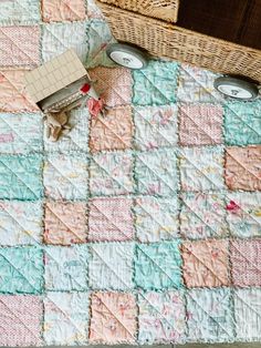 a quilted table with two wicker baskets next to it and an empty basket on the floor