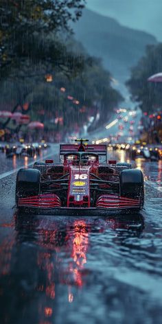 a red race car driving down the street in the rain with its lights on and it's raining