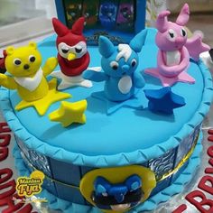 a birthday cake decorated with cartoon characters on it