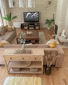 a living room filled with furniture and a flat screen tv on top of a wooden table