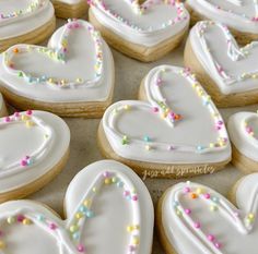 decorated heart shaped cookies sitting on top of a table