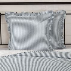 a bed with blue and white striped sheets