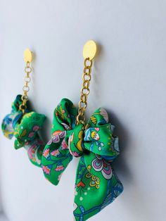 A bold, fun and colourful statement dangle earring featuring an oversized silk bow suspended from a gold plated rolo chain. Available in a variety of beautiful Liberty prints and also available as a regular size.  Each earring set is designed and handmade by myself in my Dartmoor Devon studio, UK Material 100% silk Liberty print bow Chain: Gold plated rolo chain  Available in 5 beautiful Liberty print options (Please see my other listings). Measurements Length (whole earring): Approx 9cm Bow Wid Chic Green Earrings For Gift, Bold Green Earrings For Gift, Bold Green Earrings For Gifts, Playful Green Earrings For Party, Playful Green Earrings For Parties, Chic Handmade Green Jewelry, Bow Earring, Architectural Jewelry, Jewelry Sets Handmade