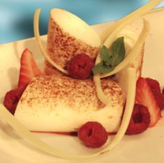 a dessert with strawberries and cream on a white plate