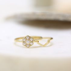 a diamond ring sitting on top of a table