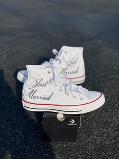 pair of white sneakers with just married written on them