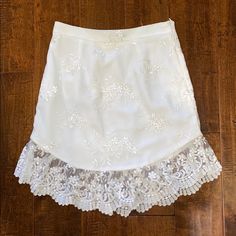 Nbd White/Ivory Lace Skirt. Bought From Revolve. Size Small. Great Condition. Never Worn Before. Product Details: Nylon Blend. Fully Lined. Embroidered Mesh Fabric. Scalloped Hem. Hidden Zipper Closure. Skirt Measures Approx 18” In Length. Feminine Lace Mini Skirt With Lace Trim, Elegant White Lace Mini Skirt, Bohemian Mini Skirt With Lace Trim, White Lace Mini Skirt With Ruffles, White Lace Trim Mini Skirt, Scalloped Hem, Ivory Lace, Mesh Fabric, White Silver