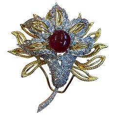 Cabochon Ruby & Diamond Floral Brooch 1 Cabochon Ruby surrounded by 108 antique cut diamonds all set in yellow and white gold. Measurements: 2.5" long Brooch Diamond, Diamond Flower Brooch, Cabochon Ruby, Floral Brooch, Gold Brooches, Diamond Flower, Antique Diamond, Flower Pins, Ruby Diamond