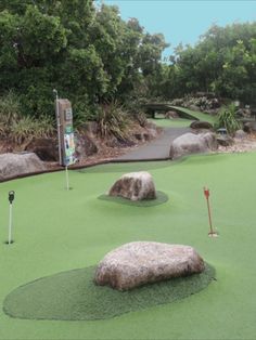 a miniature golf course with rocks and green grass