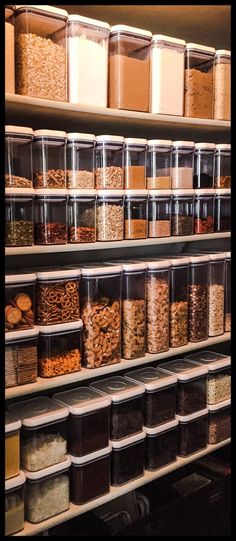 the shelves are filled with many different types of cereals and other food items in plastic containers