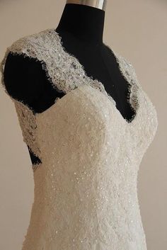 a white wedding dress on a mannequin with beading and sequins