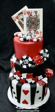 a casino themed cake with playing cards on top