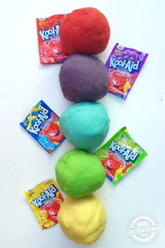 colorful play doughs and candy on a white table