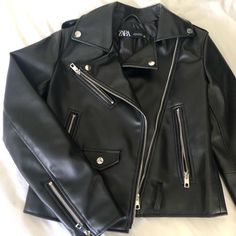 Purchased From Zara - Brand New - Never Worn, But Took Off The Tags Originally $70 Size: Xs Jacket With Lapel Collar And Long Sleeves. Front Metal Zip Pockets. Epaulettes. Self Belt With Buckle. Front Metal Zip Closure Link To Jacket: Https://Www.Zara.Com/Us/En/Faux-Leather-Biker-Jacket-P03046029.Html?V1=80093446&Gclid=Cj0kcqia0md_brctarisadxoopbk3jsw6aw7oghdj4th0sdbzxlxt-6opx928yy_ojrc-59kpxozj7qaakrrealw_wcb Zara Trendy Faux Leather Jacket, Chic Zara Leather Jacket With Zipper Closure, Chic Zara Biker Jacket With Zipper Closure, Trendy Zara Leather Jacket With Zipper Closure, Trendy Zara Leather Jacket With Zipper, Chic Zara Biker Jacket For Streetwear, Zara Faux Leather Outerwear For Night Out, Trendy Black Zara Biker Jacket, Zara Brand