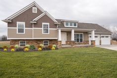 a large house with two garages in the front yard