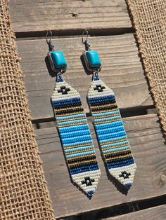 Goregous loom beaded earrings dangled from faux turquoise hook earrings. A set of simple yet western elegant Turquoise Beaded Southwestern Earrings, Adjustable Southwestern Beaded Earrings With Ear Wire, Turquoise Bohemian Beaded Single Earring, Handwoven Turquoise Bohemian Earrings, Bohemian Handwoven Turquoise Earrings, Southwestern Dangle Beaded Earrings, Adjustable Artisan Turquoise Beaded Earrings, Handwoven Turquoise Jewelry For The Beach, Turquoise Handwoven Jewelry For The Beach