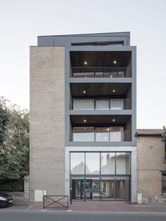 an apartment building with balconies on the second floor