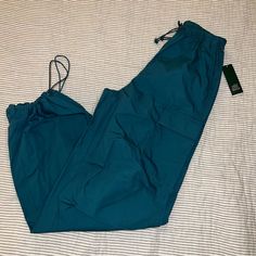 Nwt Wild Fable Teal Parachute Pants Size Xxs But Would Fit Up To A Small Oversized Fit Blue Stretch Pants With Cargo Pockets, Stretch Blue Pants With Cargo Pockets, Blue Full-length Parachute Pants, Blue Stretch Wide Leg Cargo Pants, Blue High Waist Stretch Parachute Pants, Stretch High Waist Blue Parachute Pants, Blue High-waist Parachute Pants With Pockets, High Waist Blue Parachute Pants With Pockets, Blue Wide-leg Cargo Pants For Spring