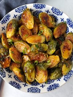 a bowl filled with brussel sprouts on top of a white table