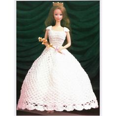 a doll wearing a white dress and holding a flower