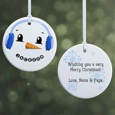 two personalized christmas ornament hanging from strings with snowflakes in the background