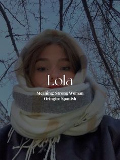 a woman wearing a scarf with the words lola in front of her and trees behind her