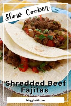 shredded beef fajitas on a plate with text overlay that reads slow cooker shredded beef fajitas