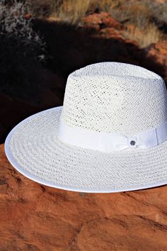 Our Palm Desert Panama fit in perfectly on our latest road trip photo shoot. Stunning, classic, chic - everything you've ever wanted in a hat. Featuring a molded crown with a pinched 10cm brim and hand woven straw, it's crystallized on the tone on tone ribbon with a simple Swarovski rivet. - 4" brim - Adjustable inner drawstring for custom sizing White Straw Hat For Spring With Flat Crown, White Flat Crown Sun Hat For Spring, White Woven Fedora With Curved Brim, White Flat Crown Straw Hat For Kentucky Derby, Elegant Woven Straw Hat For Travel, Elegant Brimmed Straw Hat Made Of Paper Straw, White Panama Hat With Flat Crown For Beach, Classic Woven Sun Hat For Kentucky Derby, White Flat Crown Panama Hat For Beach