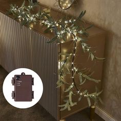 a christmas tree with lights on it next to a radiator