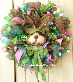 a wreath that has a bunny on it and green ribbon around the front entrance door