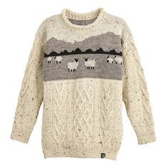 a sweater with sheeps on it and mountains in the background