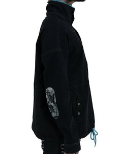 Creator's Note- Perfect anorak with comfortable pocket and neck interlining. Quantity Made- Only 100 Collection- Dawn of an Era Details- Pull string around waist hem- Hidden zipper down center- Mock neck- Neck artwork embroidered- Imported Fabric- Shell Fabric: 73% cotton / 24% polyester / 3% spandex- Combo Fabric: 100% polyester Fit- True to size Black Cotton Outerwear With Cargo Pockets, Black Utility Jacket With Patch Pockets For Outdoor, Urban Utility Jacket With Stand Collar For Streetwear, Hooded Windbreaker With Patch Pockets For Streetwear, Streetwear Outerwear With Stand Collar And Side Pockets, Casual Parka With Stand Collar And Pockets, Black Outerwear With Patch Pockets And Relaxed Fit, Casual Black Utility Jacket With Detachable Hood, Urban Style Washed Black Long Sleeve Outerwear