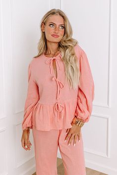 - Stay dressed to chill in this trendy top! Featuring soft material designed for comfort and style, this piece is perfect for lounging, exploring a vacay villa, or simply soaking up the good vibes. - Unlined subtly textured material - A v-cut neckline with a tie detail - Long, loose sleeves with elastic cuffs - A relaxed silhouette that ends in a peplum hemline Measurements S : Bust 40", Hip 46", Length 22", Sleeve Length 21", Waist 36". M : Bust 42", Hip 48", Length 23", Sleeve Length 22", Wais Loose Sleeves, Trendy Top, Front Tie Top, Tie Top, V Cut, V Cuts, Trendy Tops, Material Design, Soft Material