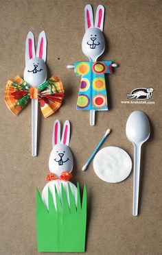 some bunny ears and spoons are sitting on the ground next to each other,