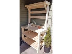 a wooden bench with shelves on the outside