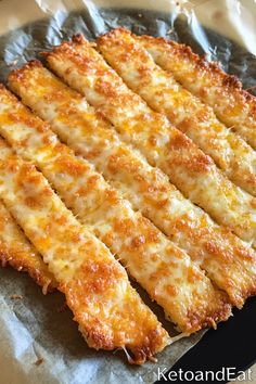 cheesy bread sticks sitting on top of a pan